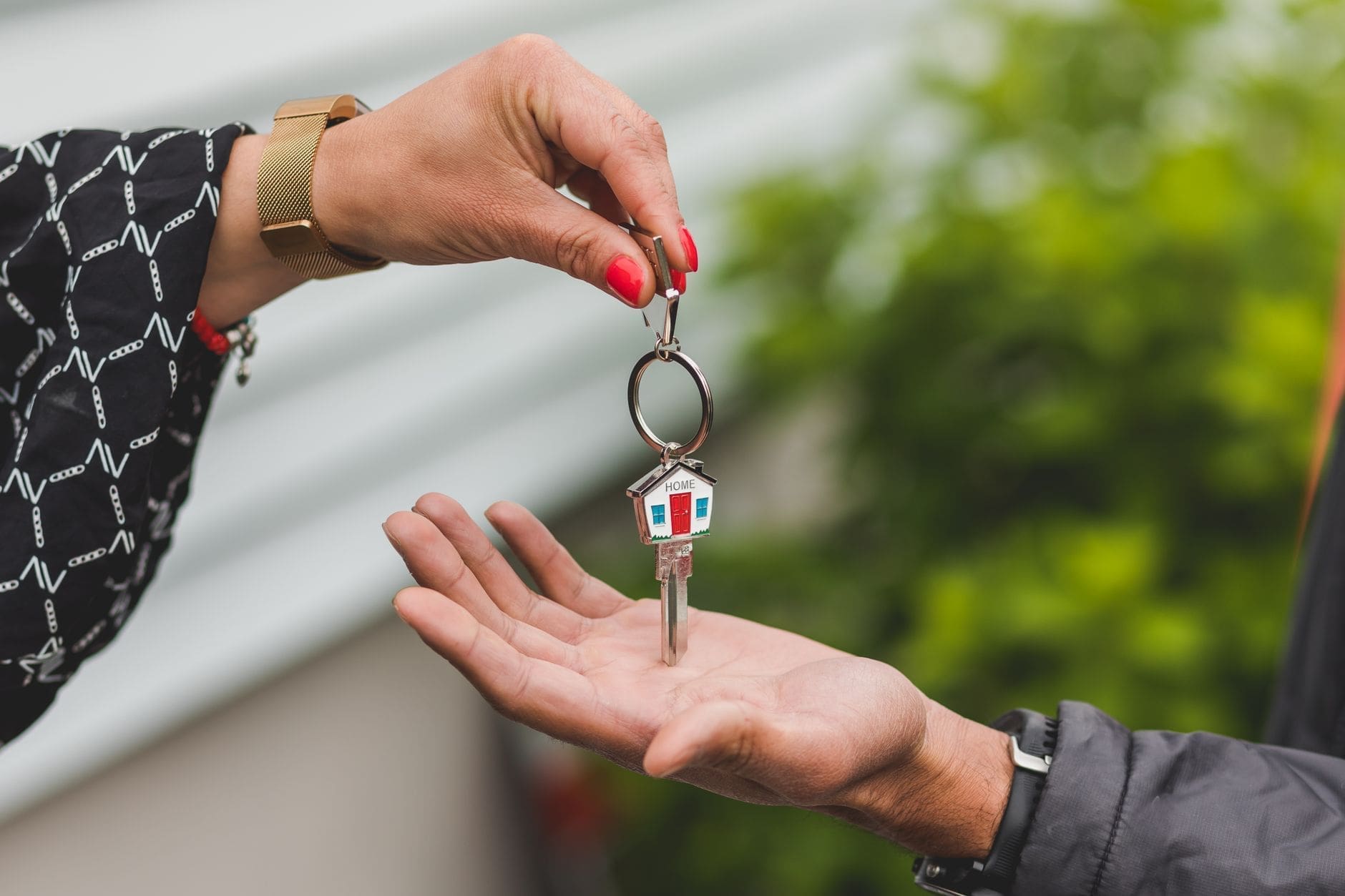 Professional handshake over house keys and property documents