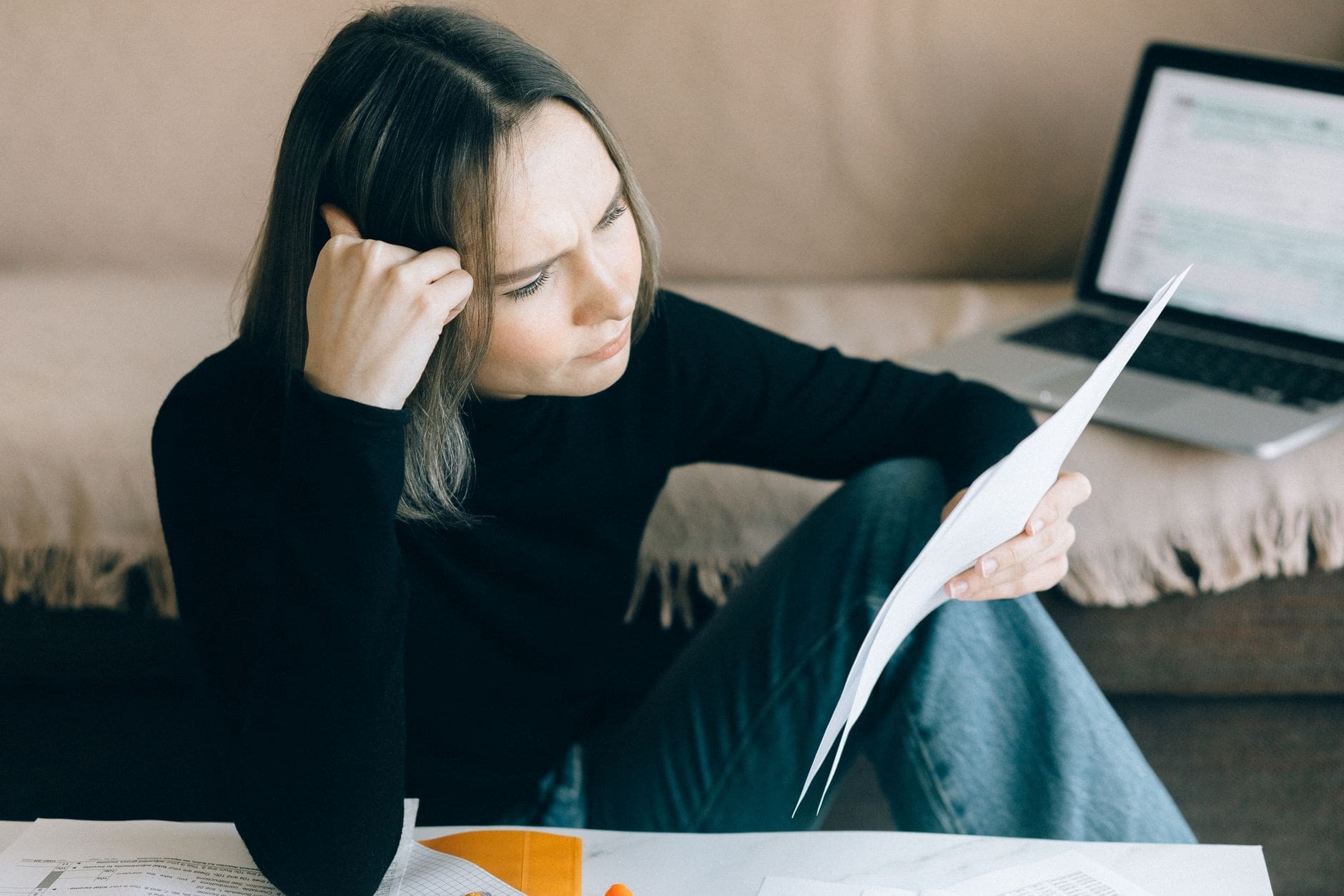 Person reading a home survey report with property documents on table